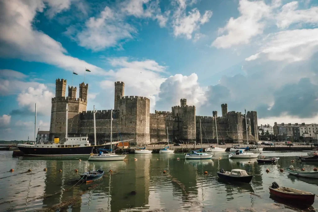 Conwy Valley Getaway | caernarfon castle Wide view of Caernarfon Castle with it's reflection on the sea in front