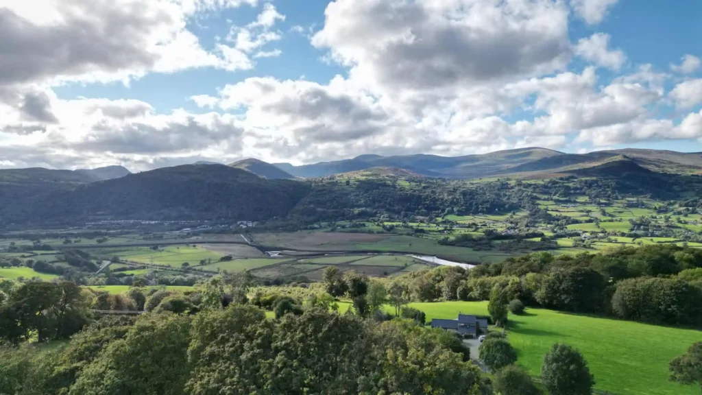 Conwy Valley Getaway | conwy valley mountain view Conwy valley guide with a wide aerial shot of the valley on a warm summer day