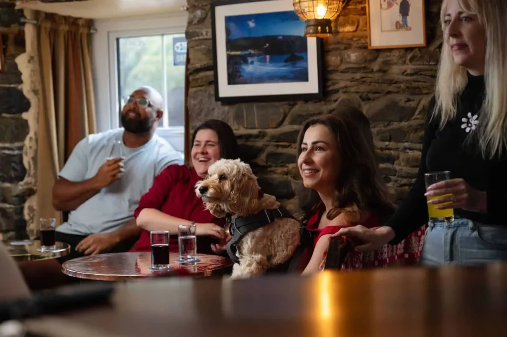 Conwy Valley Getaway | dog in pub Family and pet dog enjoying drinks in the pub