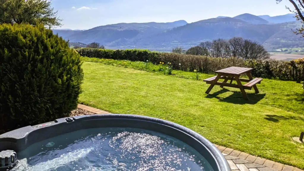 Conwy Valley Getaway | hot tub with valley views View across the spacious garden and Welsh valley from the private hot tub