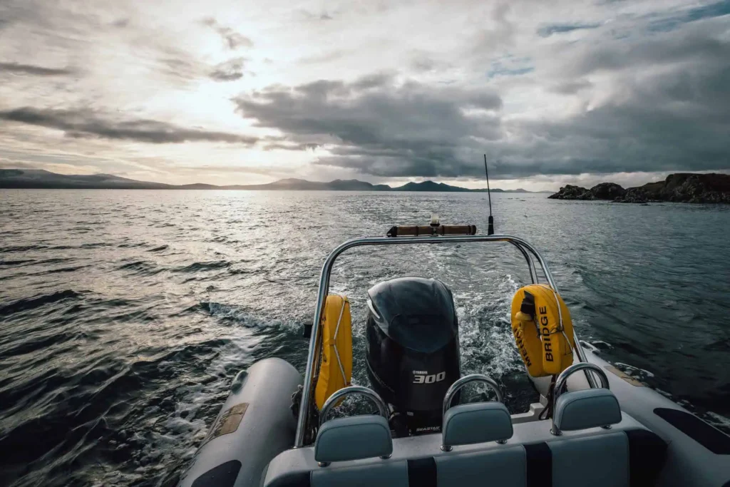 Conwy Valley Getaway | rib ride menai straits anglesey Wide view of the back of a rib with powerful engine cutting through the calm waters of the Menai Straits