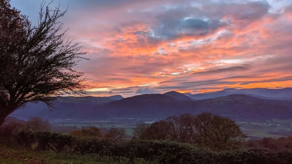 Conwy Valley Getaway | snowdonia mountains sunset A colourful pink and orange sunset over the Snowdonia mountain range, seen from the cottage