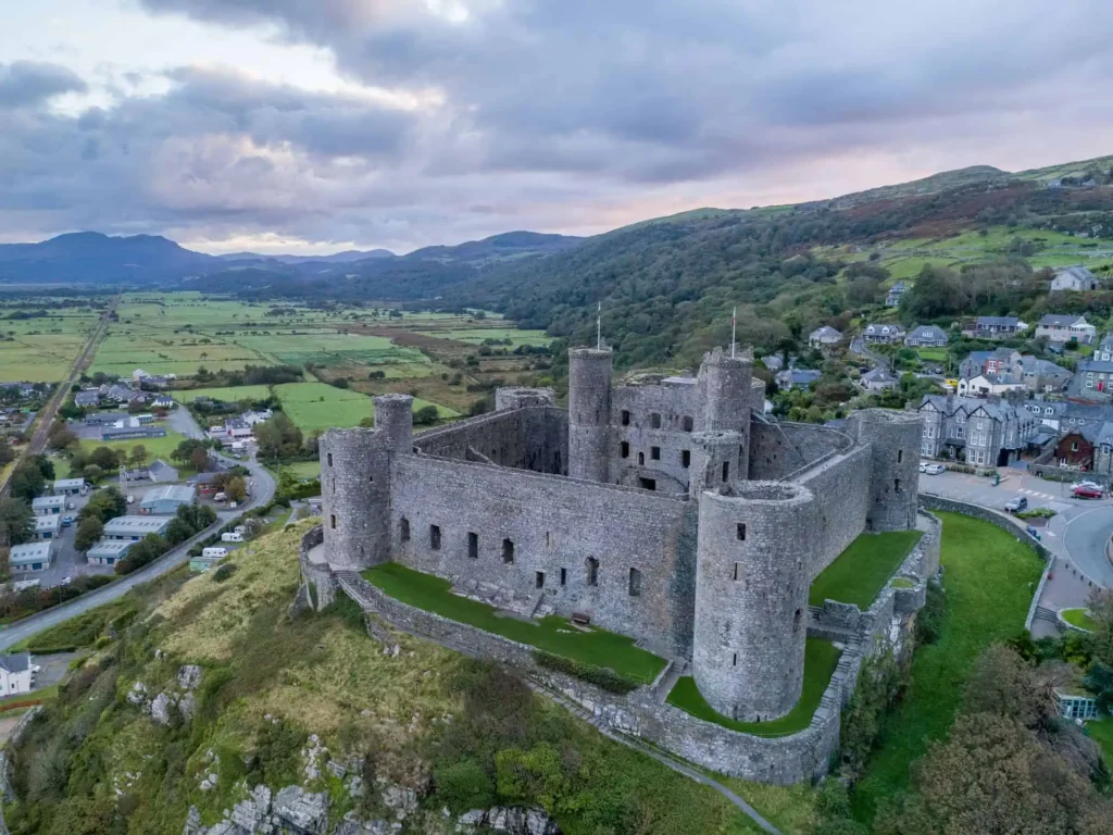 Conwy Valley Getaway | 24458 harlech castle gwynedd web optimised 1920px Aerial view of Harlech Castle with the town beyond and Eryri mountains in the background