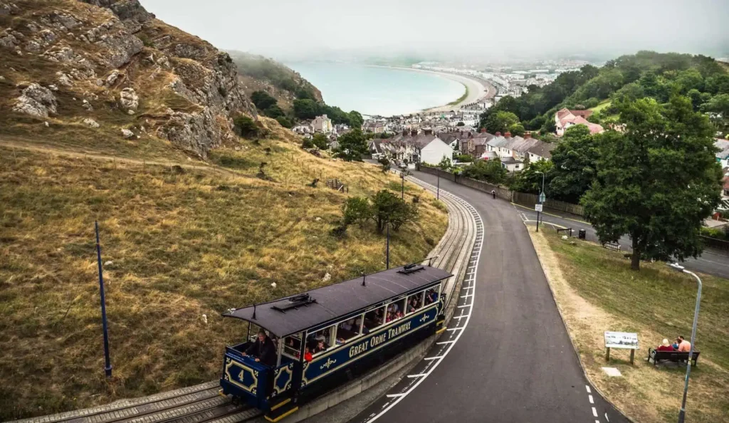 Conwy Valley Getaway | 47380 wcp great orme rail 2 1 web optimised 1920px A blue and white Great Orme tram car traveling up the steep incline in Llandudno