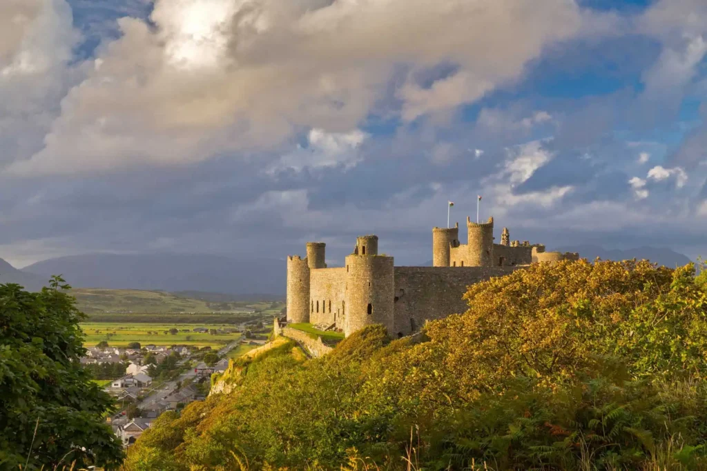 Conwy Valley Getaway | 48978 ncx kc02 1415 0319 web optimised 1920px The panoramic view from behind Harlech Castle, looking out over the rooftops of the town below, with the peaks of Eryri (Snowdonia) visible in the distance