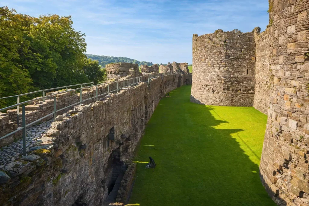 Conwy Valley Getaway | 50220 ncx kc01 1617 0243 web optimised 1920px The low outer wall of Beaumaris Castle, with its walkable stone battlements, running alongside the wide, green, water-filled moat