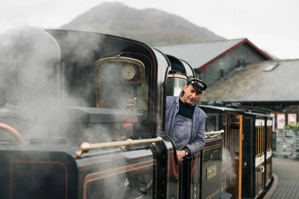 Conwy Valley Getaway | 681032 ffestiniog railway at porthmadog north wales web optimised 1920px Steam train pulling out of Ffestiniog Railway Station in Snowdonia