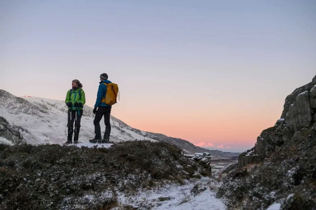 Conwy Valley Getaway | 681690 glyderau mountain eryri web optimised 1920px Two hikers enjoying the view from Glyderau in Eryri on a cold winter day with snow on the ground