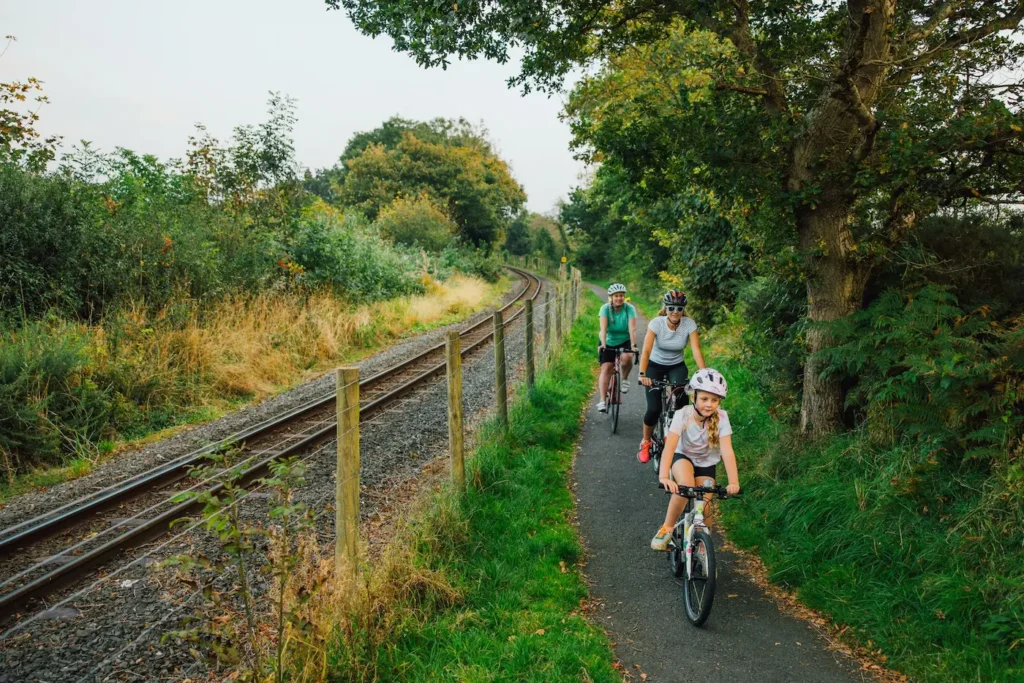 Conwy Valley Getaway | 687303 nvw g47 2425 0087 web optimised 1920px Family cycling on cycle path beside a railway track in North Wales