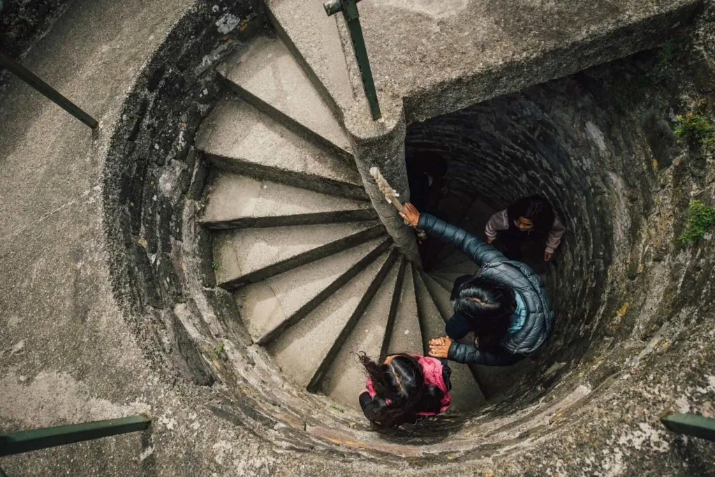 Conwy Valley Getaway | 732380 conwycastle 71 web optimised 1920px Family climbing up the winding stone steps leading to the top of one of the towers in Conwy Castle
