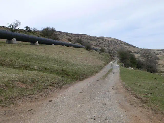 Large pipes running alongside a rural gravel track close to the village of Dolgarrog