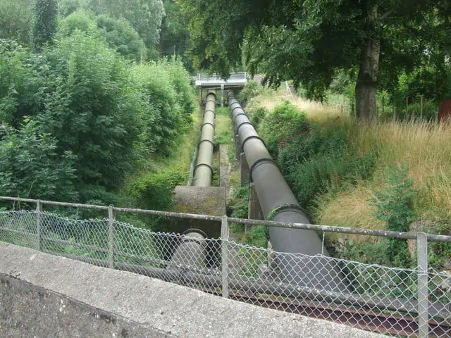 Dolgarrog pipes disappearing into the overgrowth