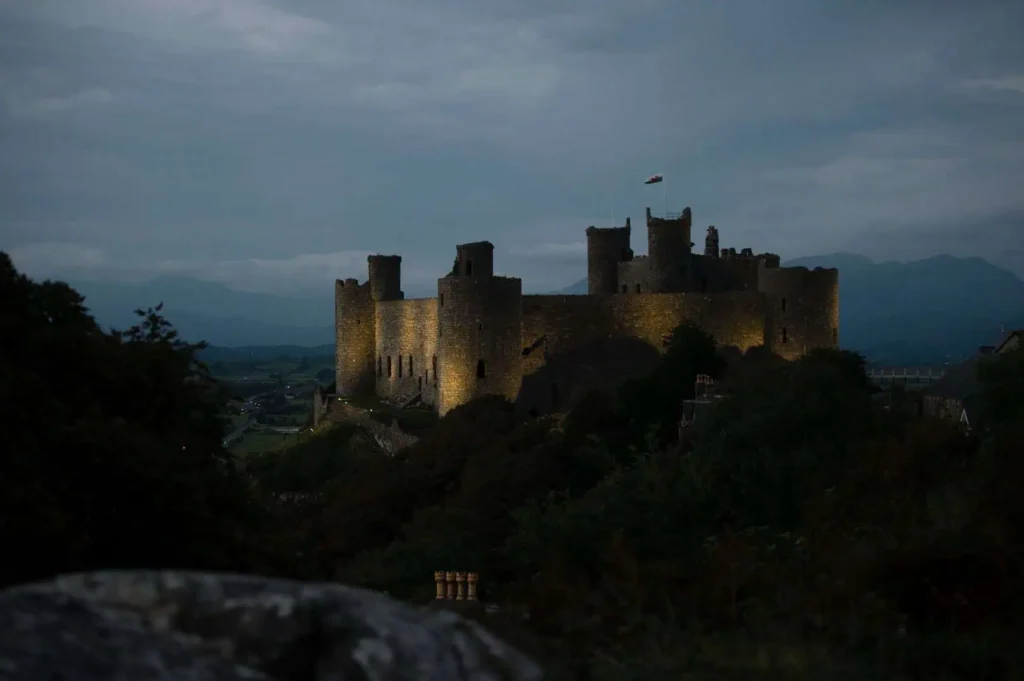 Conwy Valley Getaway | 32454 mvw c29 1617 0100 web optimised 1920px Harlech Castle glowing under night lights, its stone walls illuminated against the evening sky