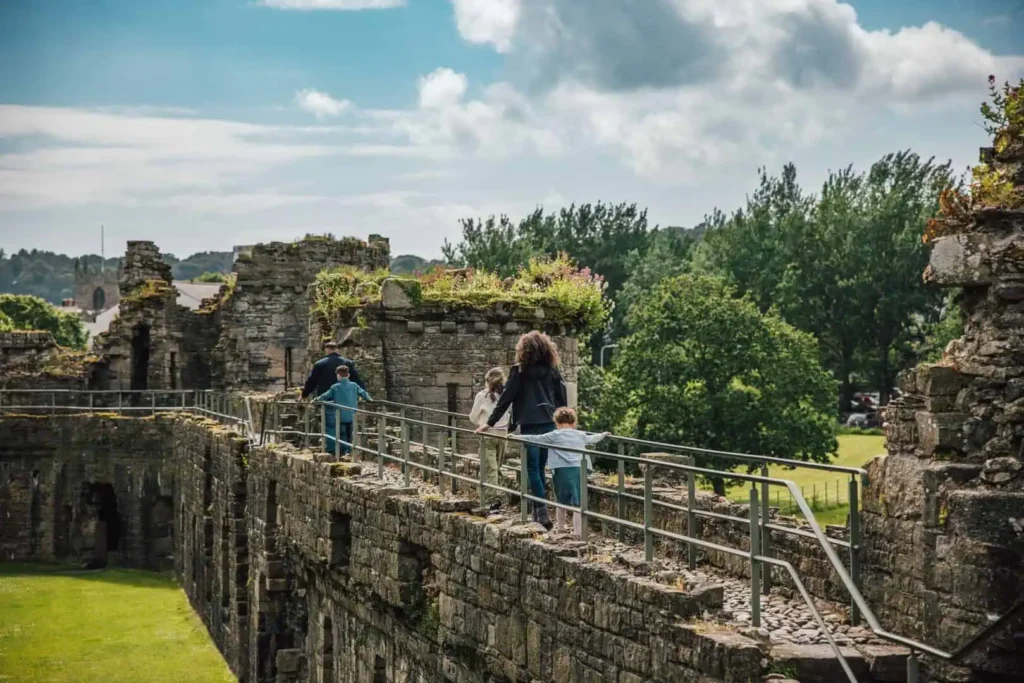 Conwy Valley Getaway | 732322 beaumariscastle 110 web optimised 1920px A family walking along the top of Beaumaris Castle’s stone walls, enjoying panoramic views over the towers