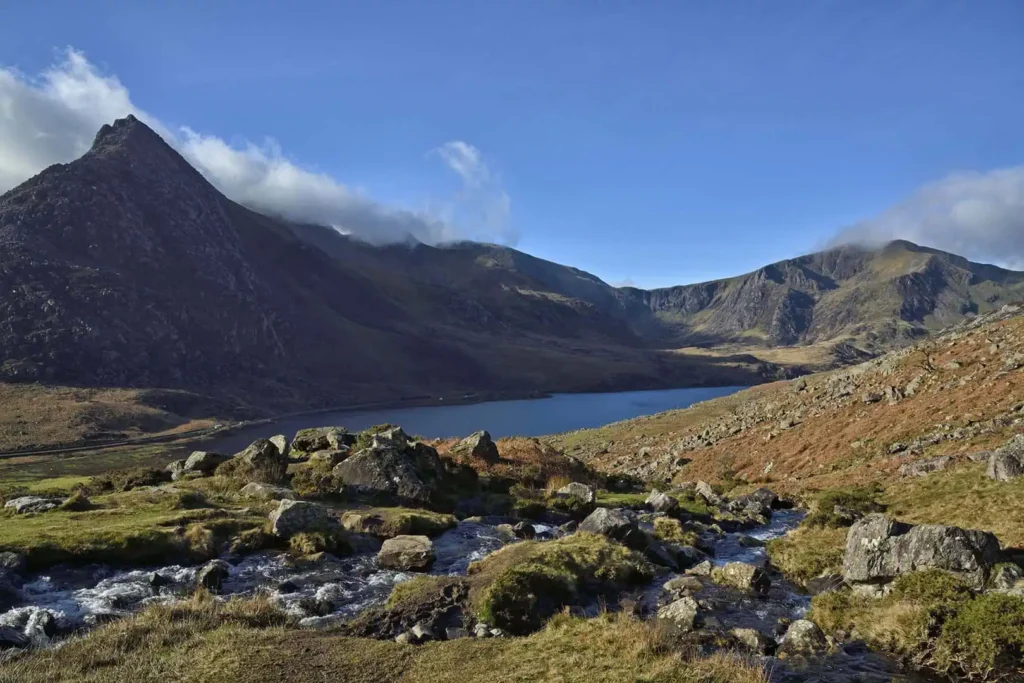 A view over the Ogwen valley and it's lake llyn Ogwen. Taken from the flanks of Pen Yr Ole Wen, a mountain in the Carneddau range. On the opposite side of the valley, Tryfan (left), Glyder Fach, Glyder Fawr, and Y Garn (right)