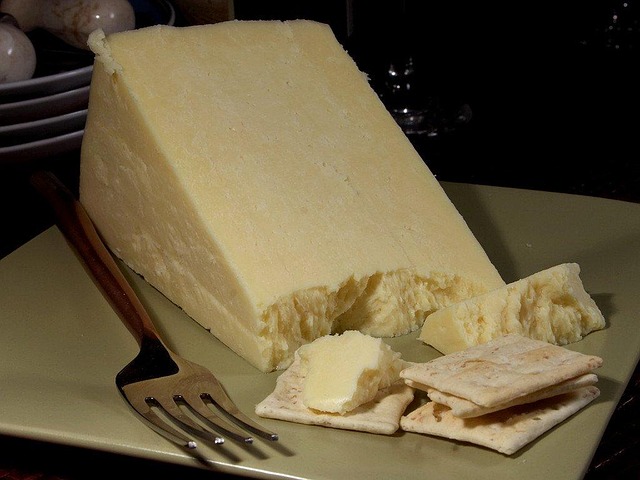 A slice of Caerphilly, a hard, crumbly white cheese that originated in the area around the town of Caerphilly, Wales