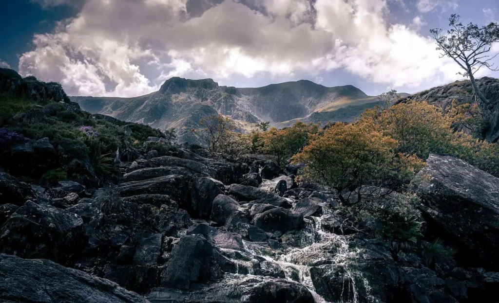 Conwy Valley Getaway | snowdon 6482820 1920 A small mountain stream flowing over mossy rocks in Eryri National Park.