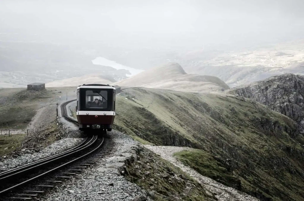 Conwy Valley Getaway | train 5922069 1920 Mountain train moving through frosty, wintry scenery in Eryri