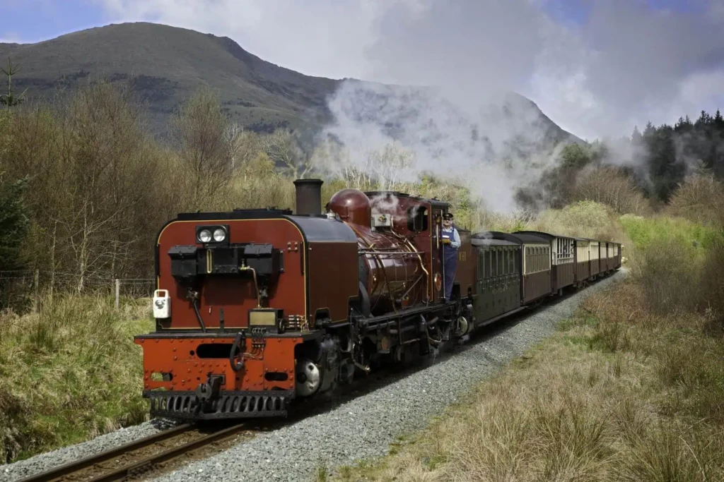 Locomotive south of Rhyd Ddu with Mynydd Drws y coed in background Welsh Highland Railway Snowdonia