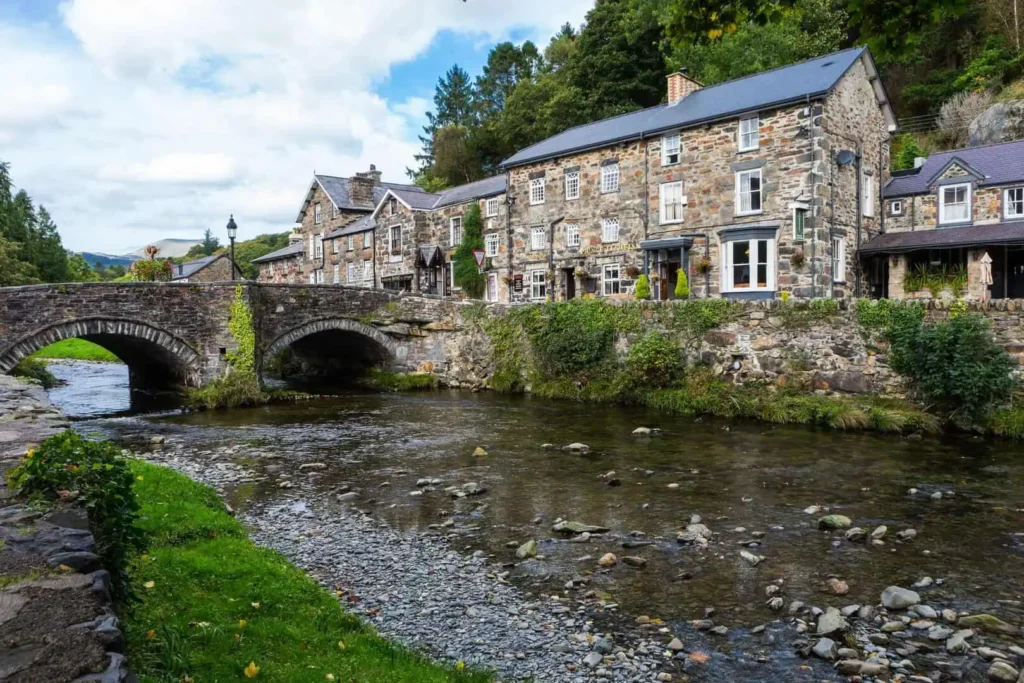 Beddgelert Bridge is a three arch stone structure, consisting of two main arches spanning the river and a smaller flood arch on the south side
