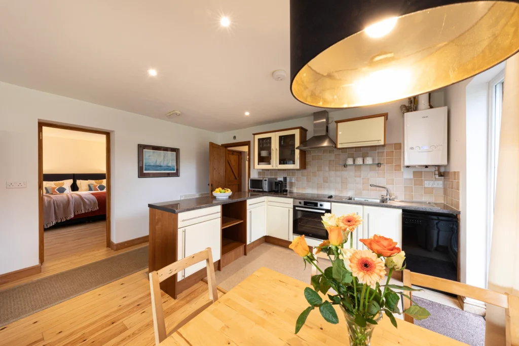 Fig Tree open-plan kitchen and dining area, bedroom visible beyond
